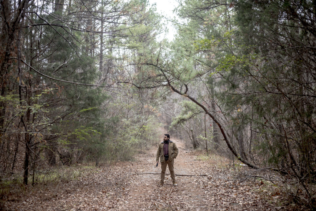 Brian Reed, host of S-Town, somewhere in the woods of Bibb County, Ala.